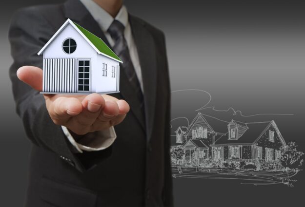 businessman shows a house home remodeling value